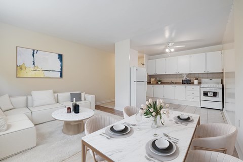 A modern dining room with a white table set for four.